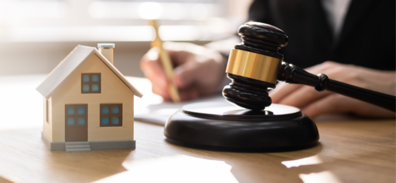 4 Pros and Cons of Selling The House After Divorce: Judge with gavel, small house