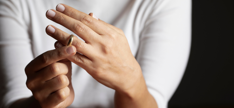 close up of woman's taking off her wedding ring
