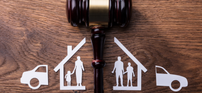 silhouette of a family in a house split in half with a gavel